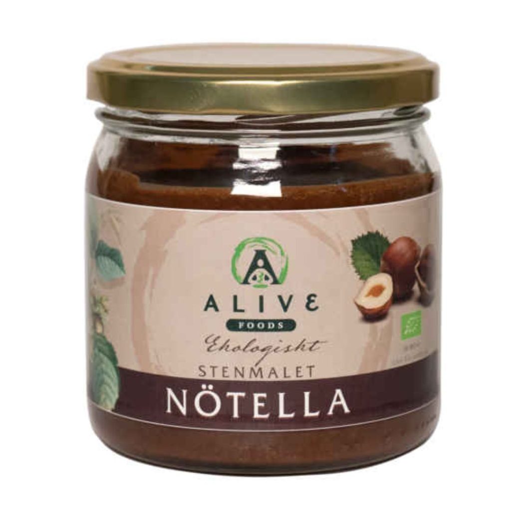 Glas med Alive Foods Nötella med beige etiket og grønt logo.