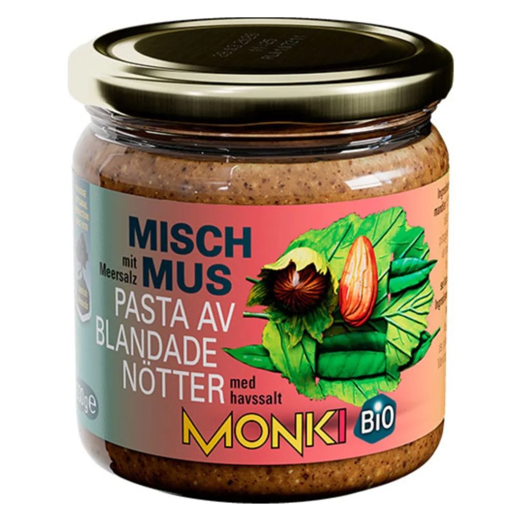Glas med Monki økologisk hasselnød- og mandelsmør med lyserød etiket.