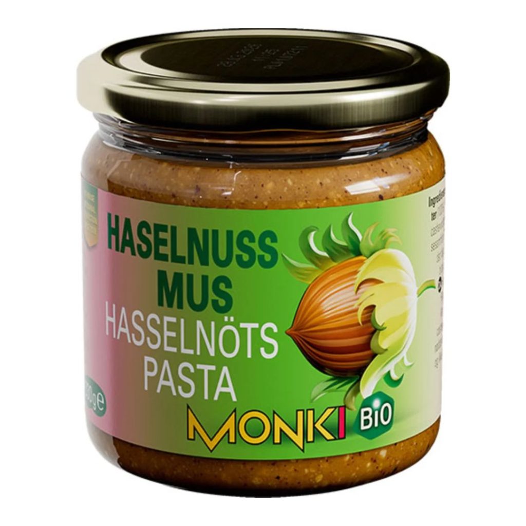 Glas med Monki økologisk hasselnøddesmør med grøn og lyserød etiket.