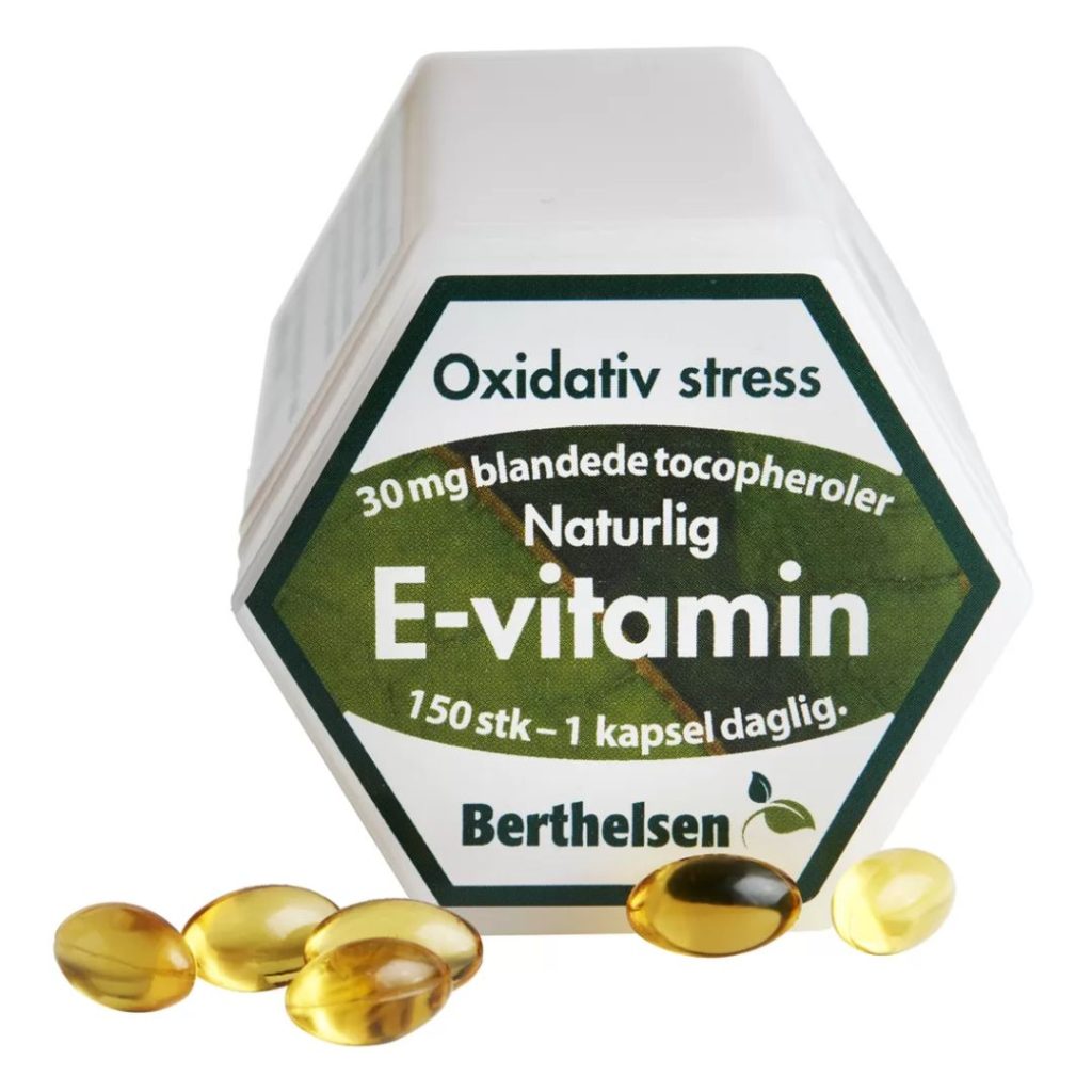 Hvid krukke med grøn etiket, der viser "Berthelsen E-vitamin 30 mg", omgivet af gule E-vitamin kapsler.